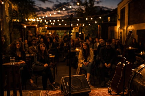 An intimate live audience scene at dusk with a guitar resting on a stand near the stage